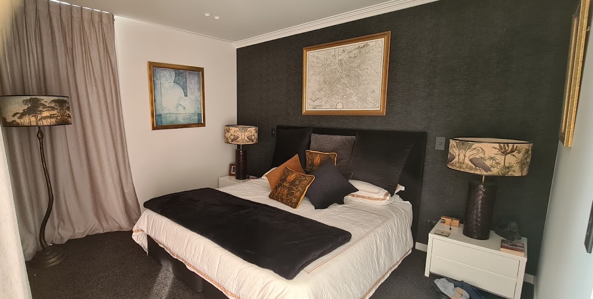 Bedroom with a dark textured feature wall